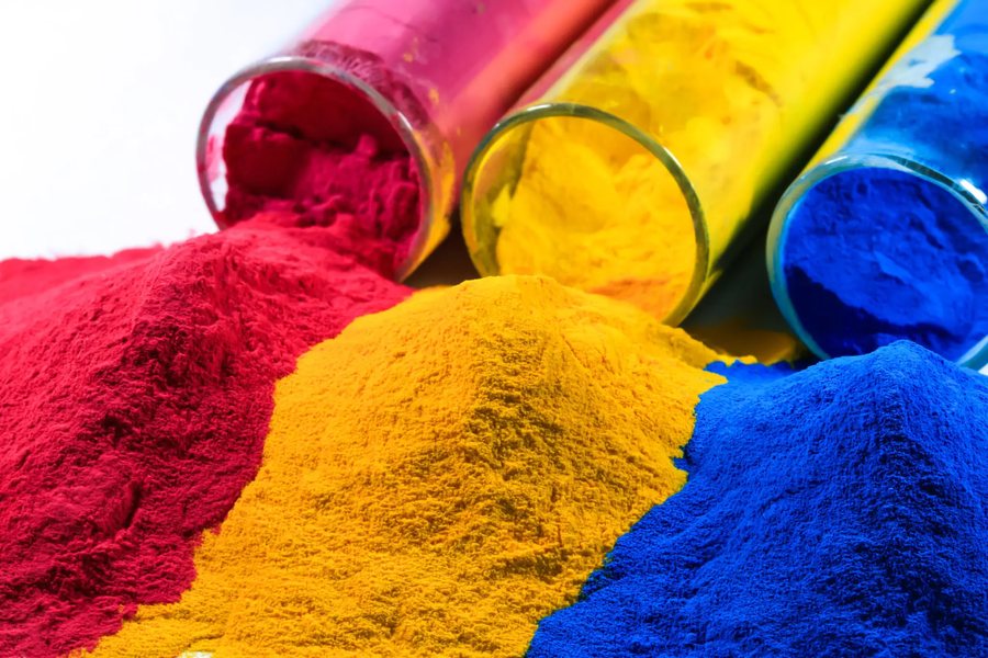 Colored chemical powders spilling from glass vials