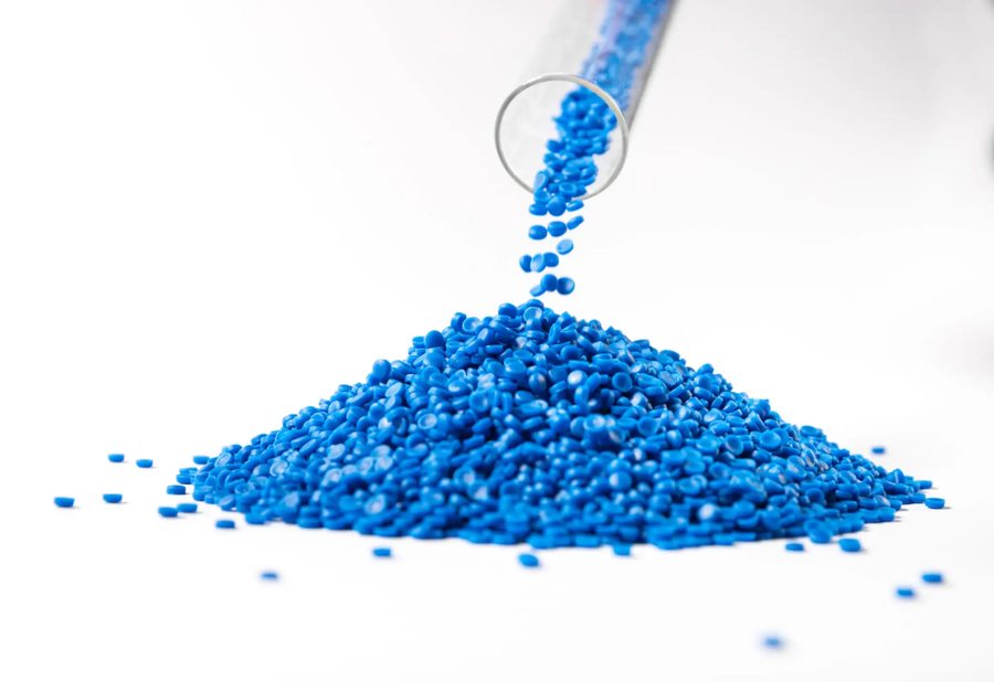 Blue polymer pellets pouring from a test tube